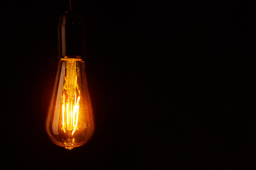 A dim lightbulb in a dark room highlights the importance of having an emergency power solution in place