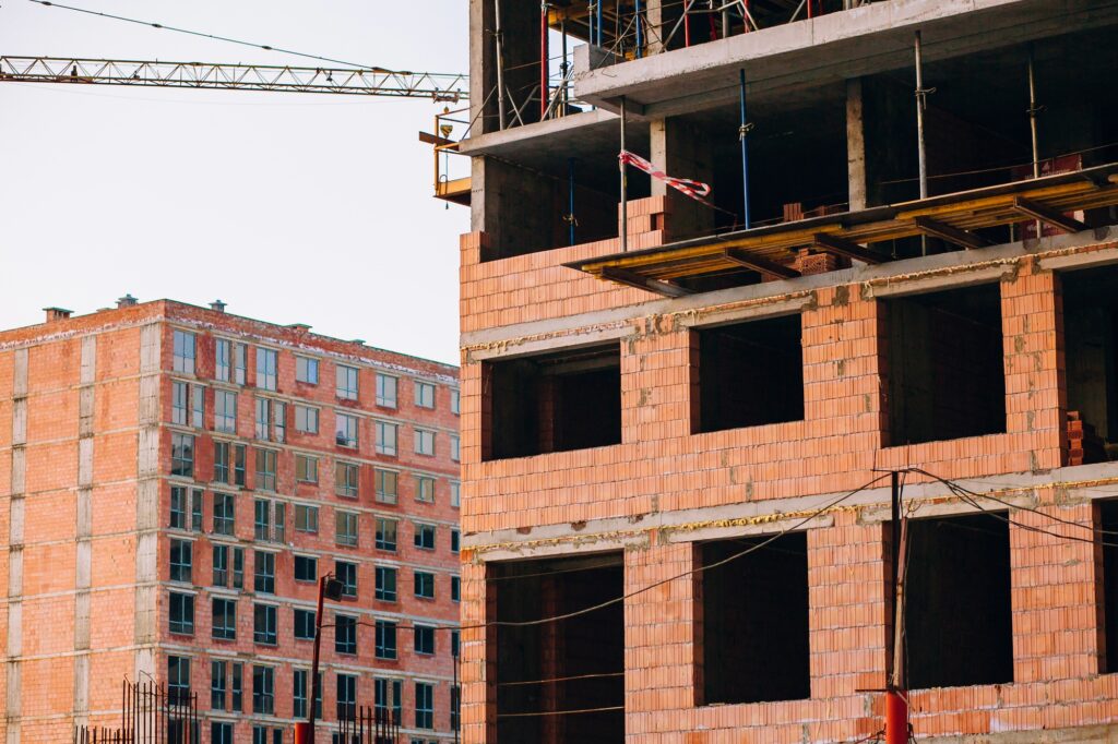 Crane and building construction site on background of sky